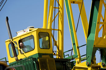 The bucket operator sticks his head out of the window while working at the Skyline Mine Wednesday. The bucket hauls uranium contaminated soil back to the top of Olijato Mesa from the bottom. © 2011 Gallup Independent / Brian Leddy  